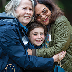 Photo of two people hugging a young child. Link to Donor-Advised Funds